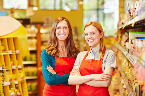 Two friendly saleswomen in a supermarket photo
