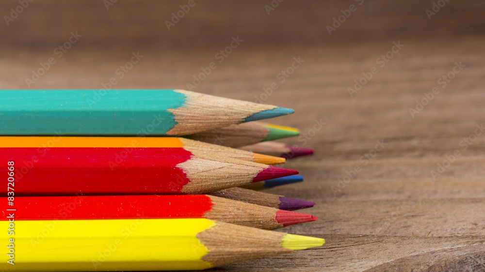 Fototapeta premium Coloured pencils on wooden background