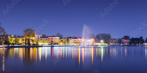 beach of city bardolino with reflections in lake at night