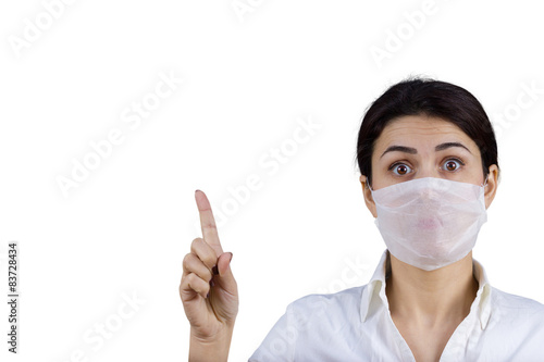 Female doctor with protective mask pointing up © nickshot