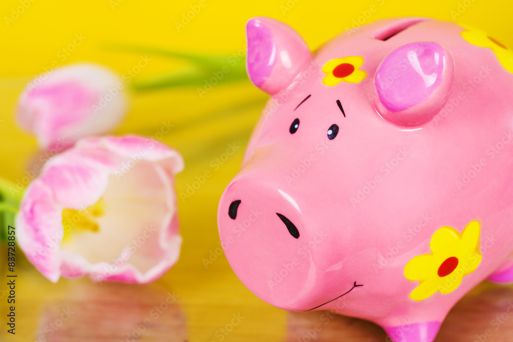 Piggy coin bank on yellow background Piggy coin bank on yellow background
