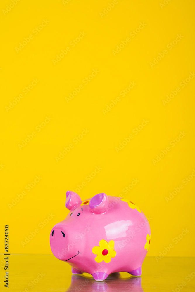 Piggy coin bank on yellow background Piggy coin bank on yellow background