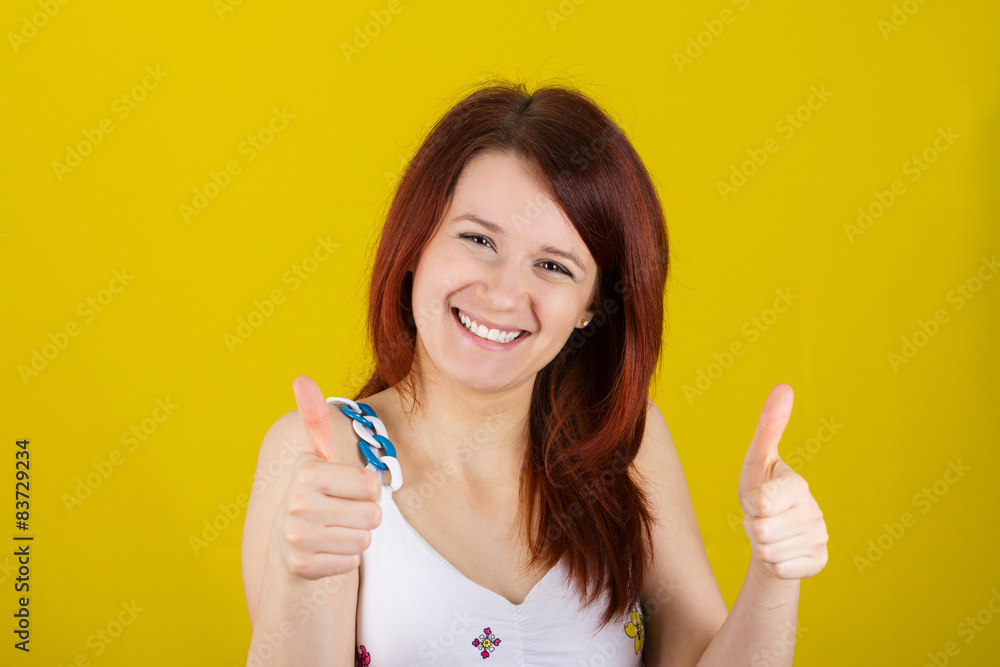 Happy surprised young woman very excited holding thumbs up Happy surprised young woman very excited holding thumbs up