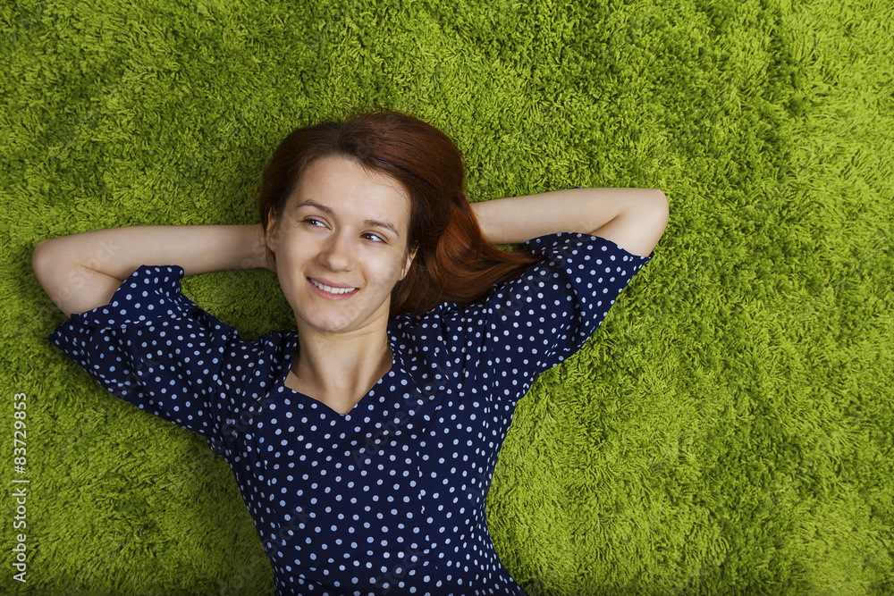 Happy woman lying down on artificial grass. Happy woman lying down on artificial grass.
