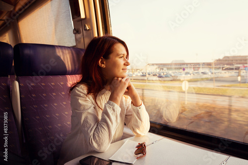 Smiling woman traveling by train.Travel Comfort