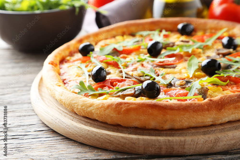 Fresh tasty pizza on grey wooden background Fresh tasty pizza on grey wooden background