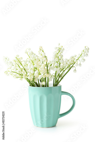 Lily of the Valley in cup on white background