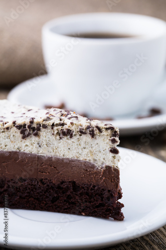 Chocolate dessert with coffee cup and coffee beans on wooden bac