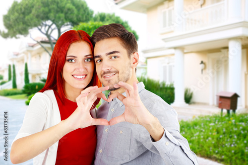 Loving couple near their house
