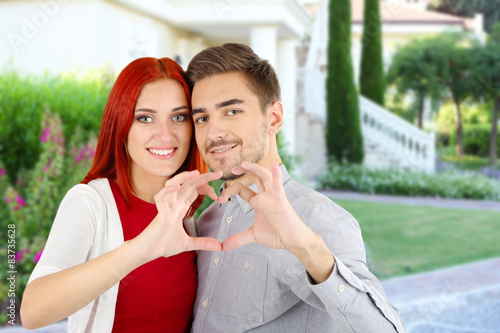 Loving couple near their house