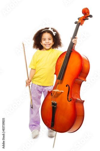 Smiling African girl holding cello and fiddlestick