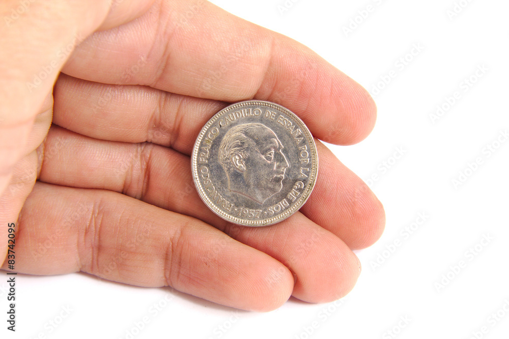 Man hand holding an old Spanish coin of 50 pesetas showing Man hand holding an old Spanish coin of 50 pesetas showing