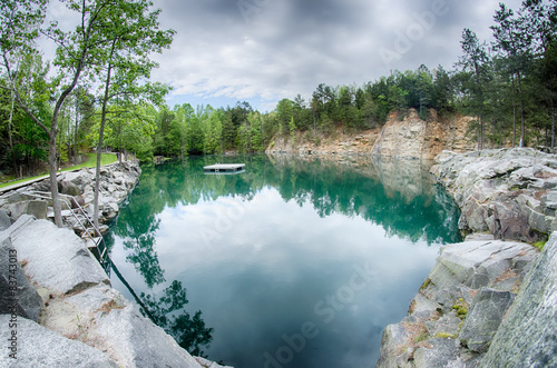 cloudy skies and reflections at a quarry photo