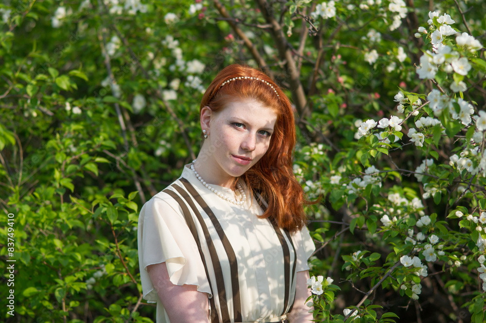 beautiful red-haired girl walks in apple orchard beautiful red-haired girl walks in apple orchard