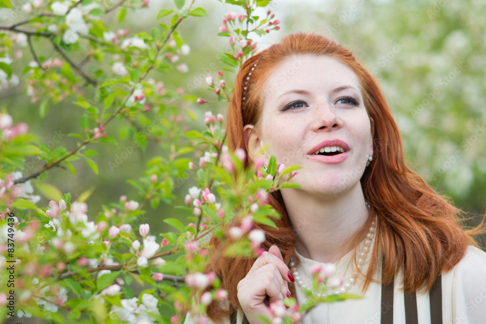 beautiful red-haired girl walks in apple orchard beautiful red-haired girl walks in apple orchard