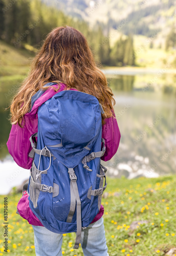 Hiker woman enjoying the lake view Hiker woman enjoying the lake view
