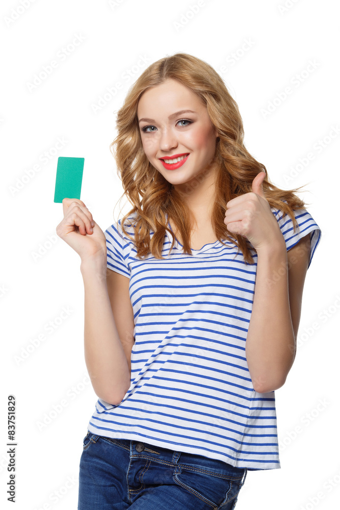 Happy smiling girl showing blank credit card and gesturing thumb Happy smiling girl showing blank credit card and gesturing thumb