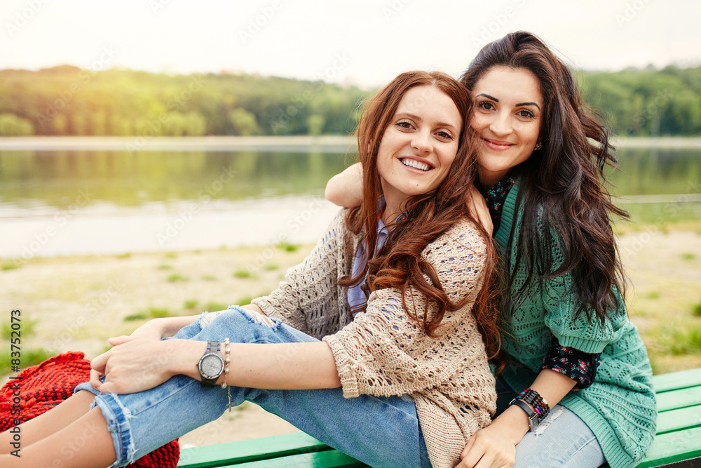 Two cheerful sisters hugging Two cheerful sisters hugging