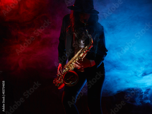 Photography Beautiful young woman plays saxophone
