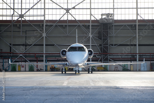 Business jet airplane is in hangar. photo