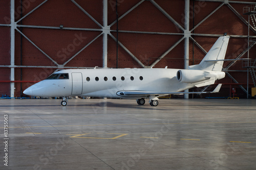 Business jet airplane is in hangar.
