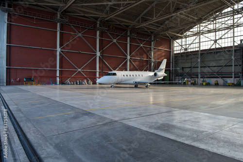 Business jet airplane is in hangar.