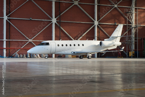 Business jet airplane is in hangar.