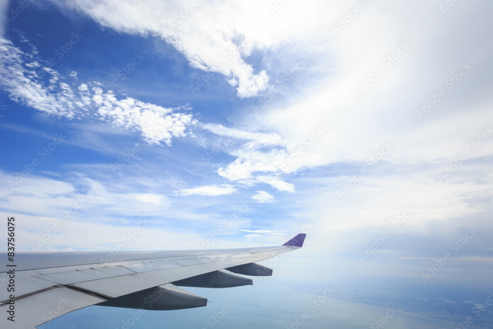 Fototapeta premium View of cloud with wing of airplane from window