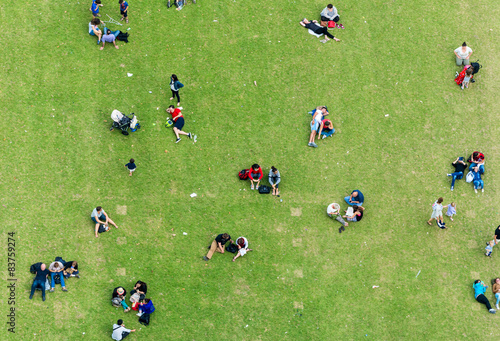Ninety degrees view of people relaxing on a meadow