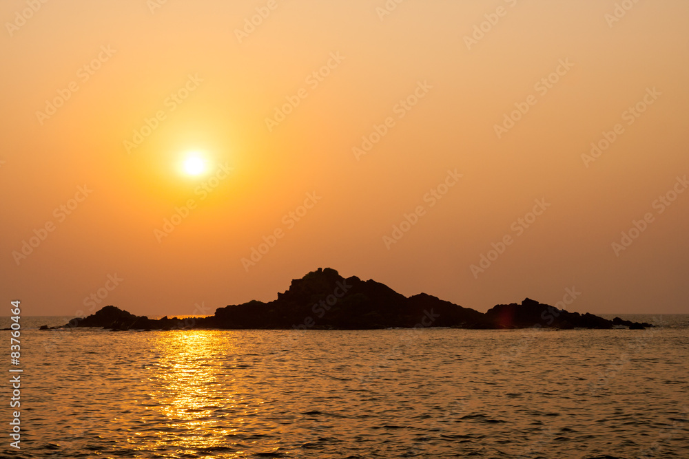 Rocky island silhouette and sunset