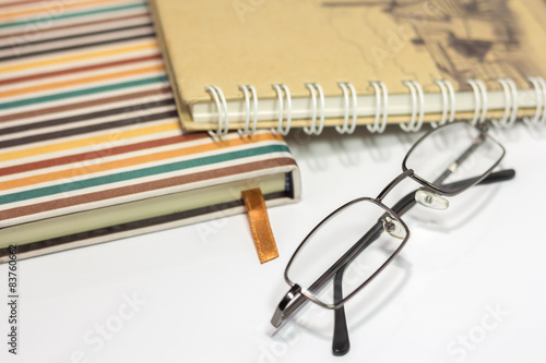Old eyeglasses and note book
