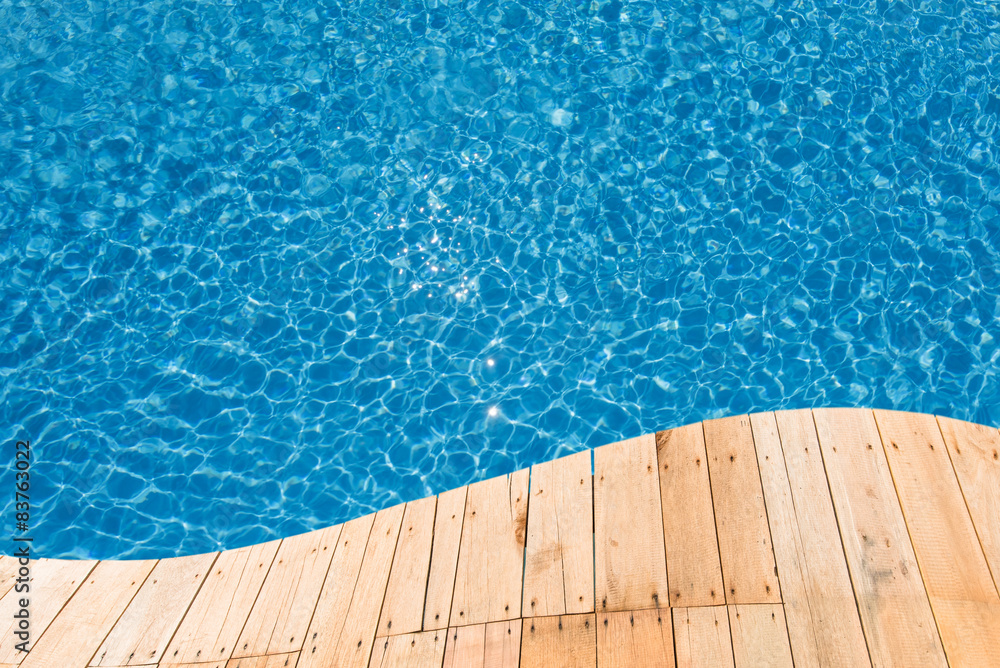 Blue swimming pool with a plank curve