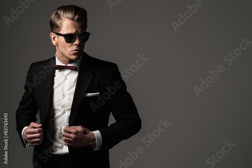 Tough sharp dressed man in black suit photo