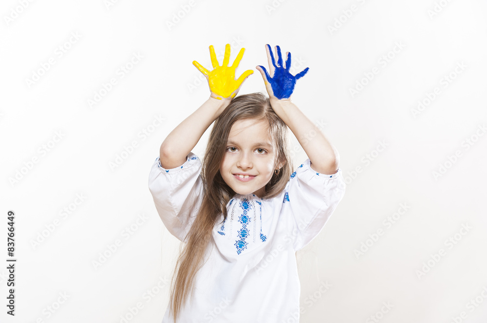 Young girl in embroidery with hands yellow and blue colors Young girl in embroidery with hands yellow and blue colors
