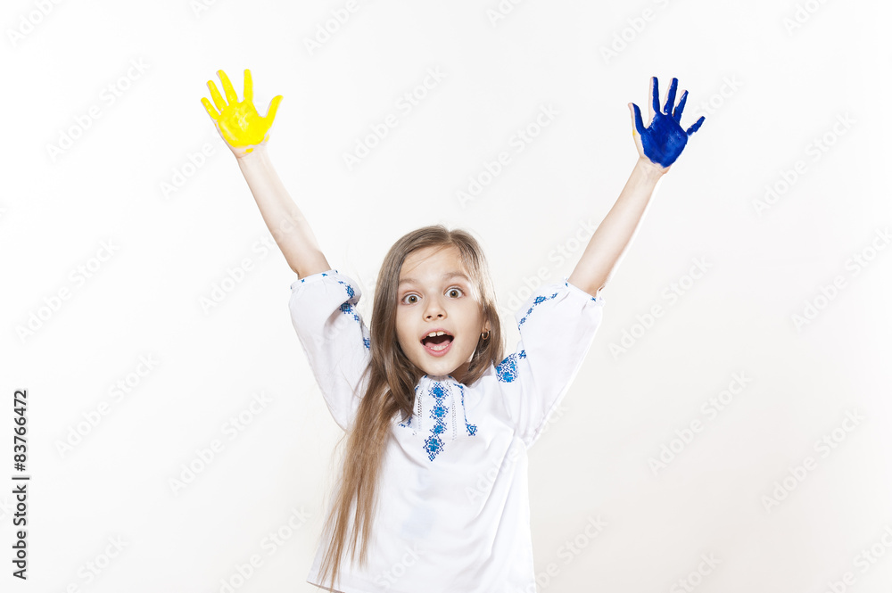 Young girl in embroidery with hands yellow and blue colors Young girl in embroidery with hands yellow and blue colors