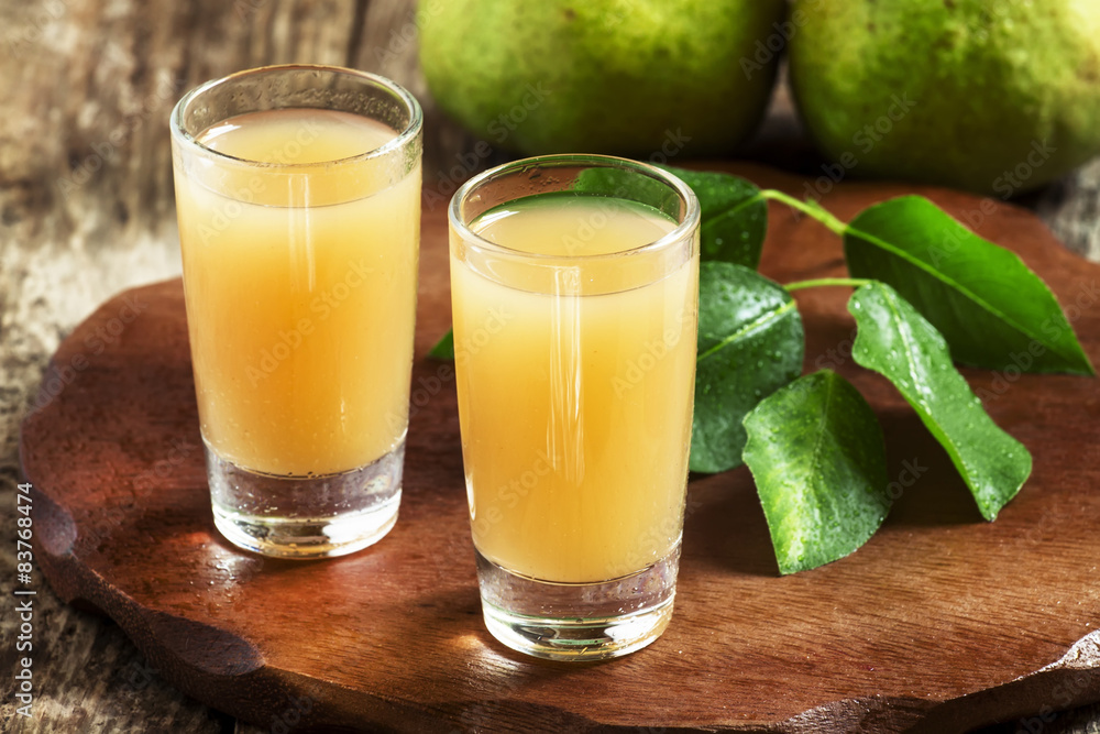 Pear fresh juice and pear on a wooden table, selective focus Pear fresh juice and pear on a wooden table, selective focus