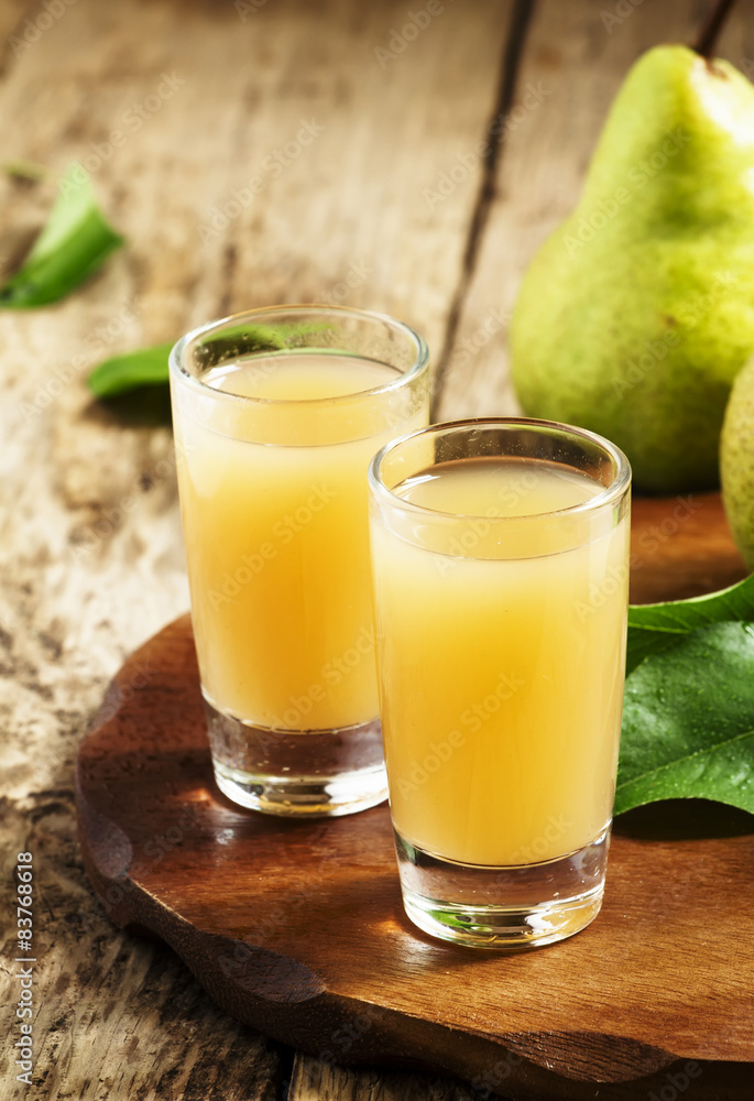 Pear fresh juice and pear on a wooden table, selective focus Pear fresh juice and pear on a wooden table, selective focus