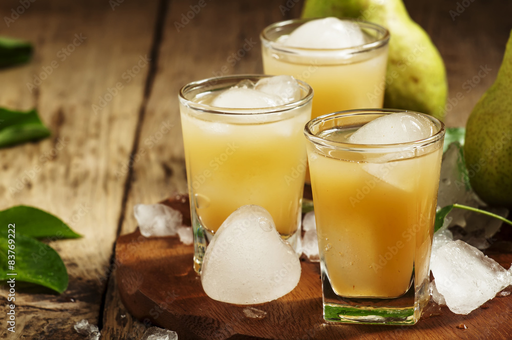 Pear fresh juice with ice in a heart-shaped and pear on a wooden Pear fresh juice with ice in a heart-shaped and pear on a wooden
