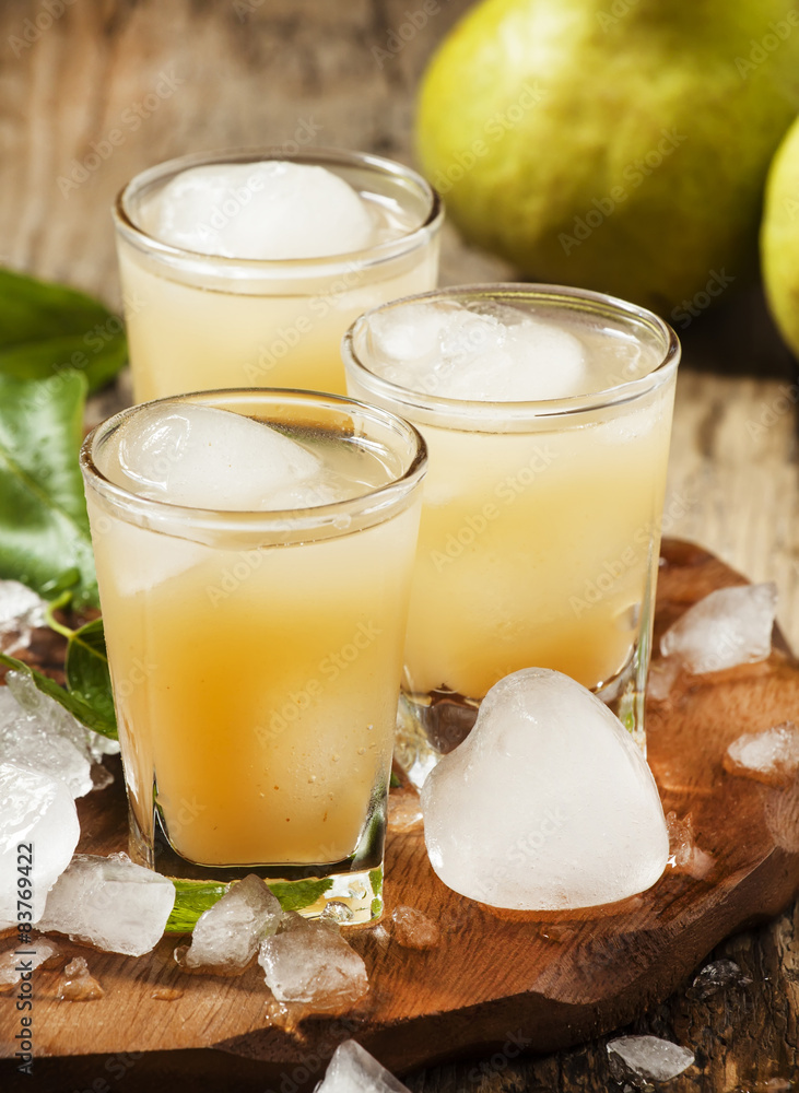 Pear fresh juice with ice in a heart-shaped and pear on a wooden Pear fresh juice with ice in a heart-shaped and pear on a wooden
