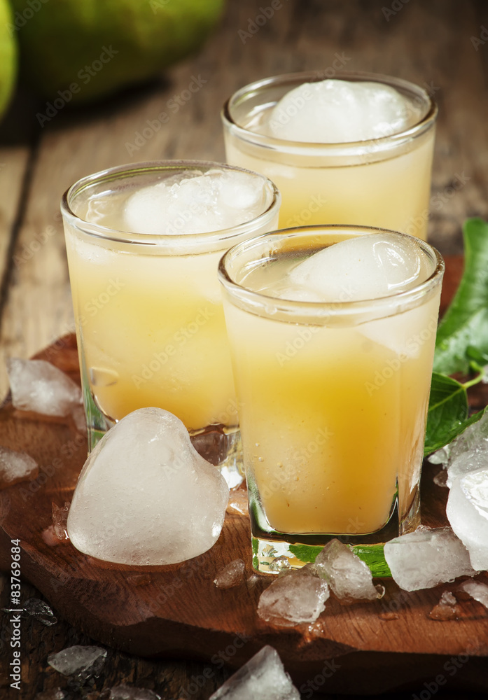 Pear fresh juice with ice in a heart-shaped and pear on a wooden Pear fresh juice with ice in a heart-shaped and pear on a wooden
