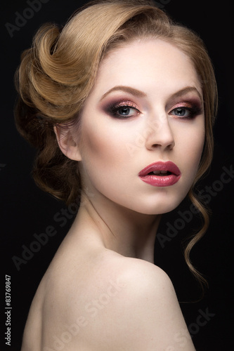 Portrait of a beautiful blond woman in the image of the bride. Picture taken in the studio on a black background. Beauty face