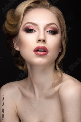 Portrait of a beautiful blond woman in the image of the bride. Picture taken in the studio on a black background. Beauty face