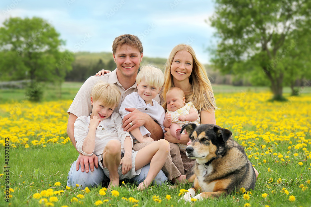 Happy Family and Pet Dog in Flower Meadow Happy Family and Pet Dog in Flower Meadow