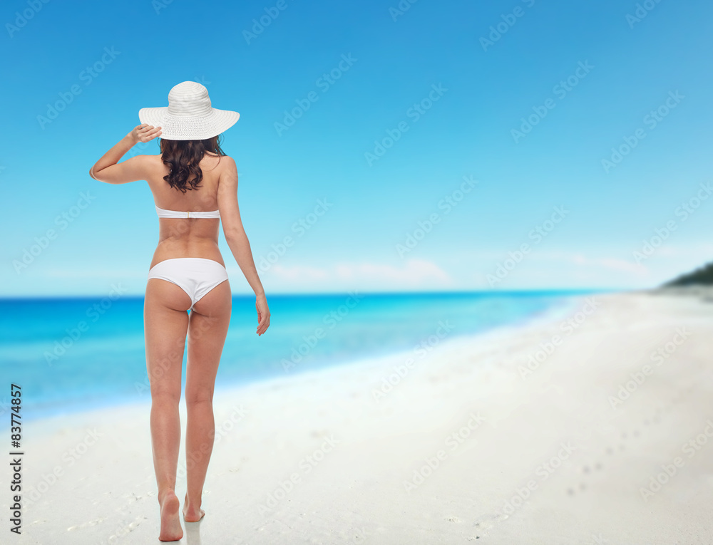young woman in white bikini swimsuit from back young woman in white bikini swimsuit from back