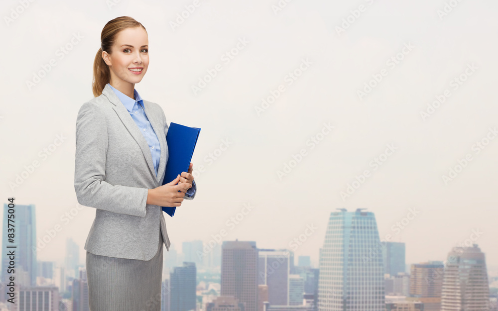smiling businesswoman holding folder