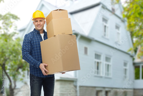 smiling man in helmet with cardboard boxes