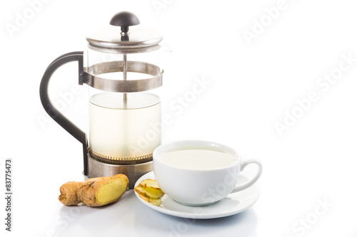 Hot ginger tea in cup with filter jar