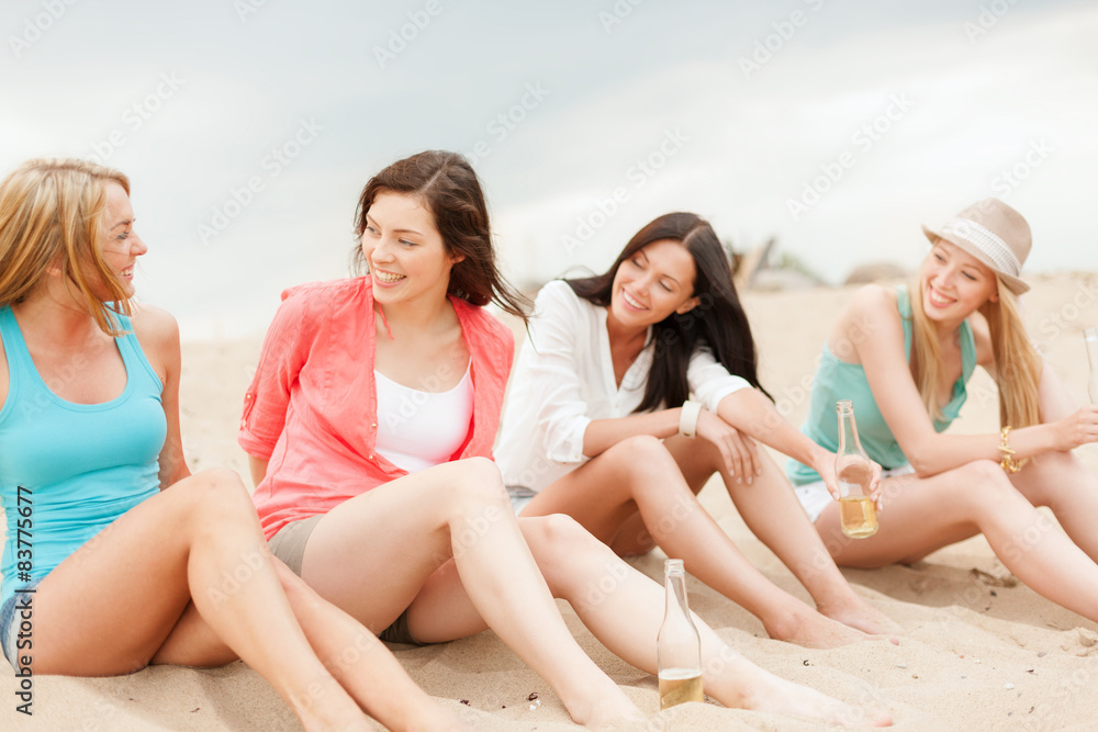 smiling girls with drinks on the beach smiling girls with drinks on the beach