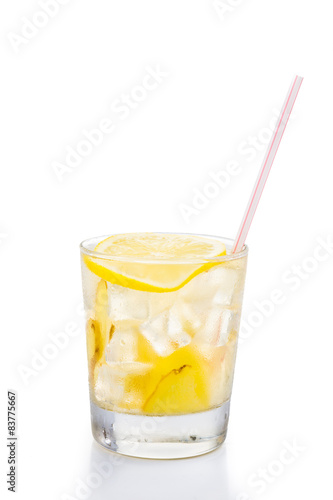 Refreshing ice cold ginger lemon tea in glass on vertical format
