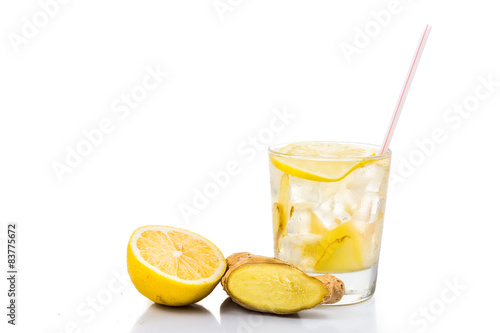 Refreshing ice cold ginger lemon tea in transparent glass